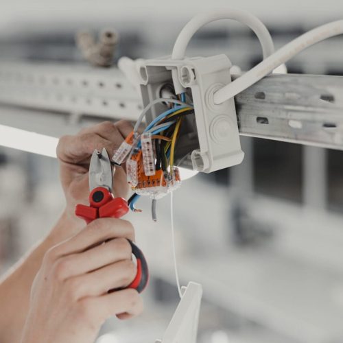 Electrical Junction Wiring, Electrical Installation, Hands of a Electrician Tightening Wires