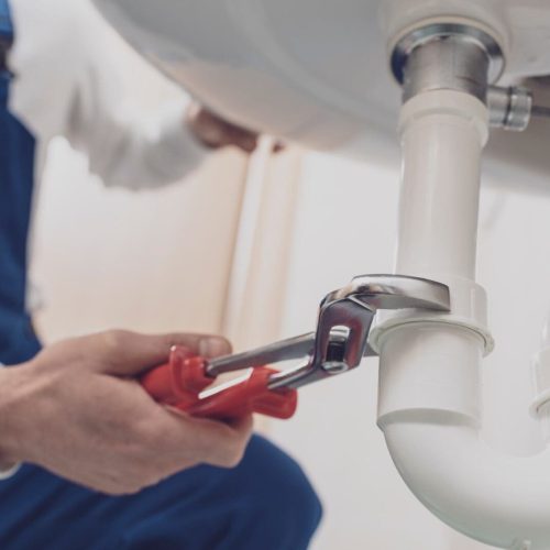 Plumber fixing a sink at home